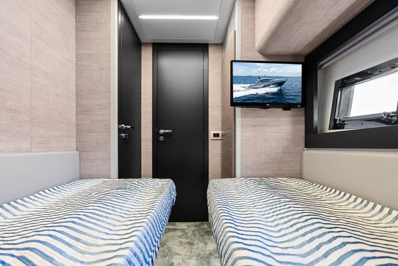 Our Trade Yacht Photos Pics Interior of 2024 Pershing 6X yacht cabin with twin beds and wall-mounted TV.