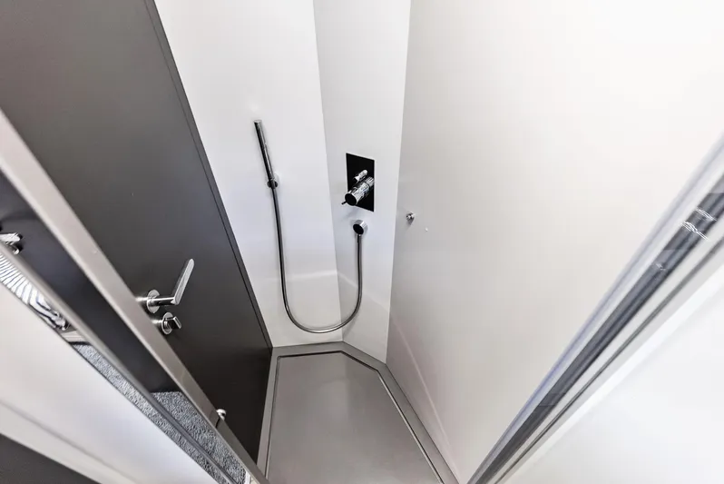 Our Trade Yacht Photos Pics 2024 Pershing 6X yacht shower area with modern fixtures and sleek design.