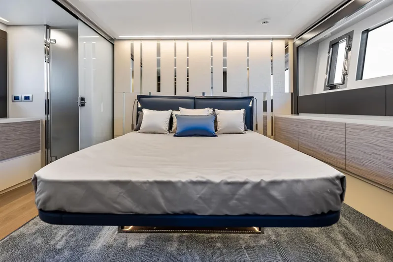 Our Trade Yacht Photos Pics Luxurious bedroom interior of 2024 Pershing 6X yacht with modern design and elegant furnishings.
