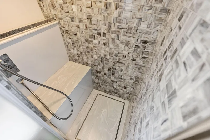 Our Trade Yacht Photos Pics Luxurious shower area in 2024 Pershing 6X yacht with elegant tile design.