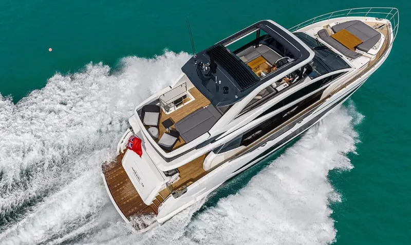  Yacht Photos Pics 2025 Pearl 72 yacht cruising on turquoise water, showcasing luxury design and spacious deck.