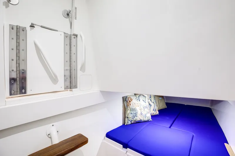 China Girl Yacht Photos Pics 2020 Valhalla V-41 interior cabin with blue cushions and decorative pillows.