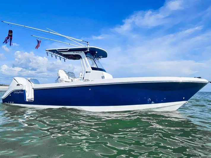  Yacht Photos Pics 2023 Edgewater 262CC boat on calm water under a clear blue sky.