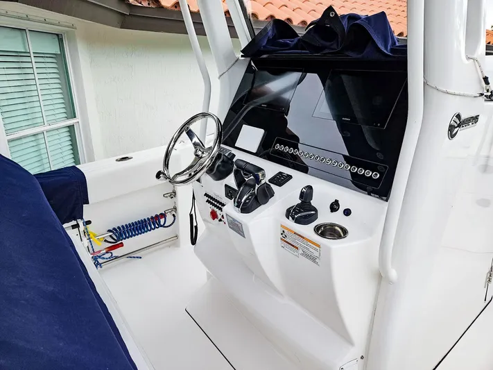  Yacht Photos Pics 2023 Edgewater 262CC boat console with steering wheel and controls.