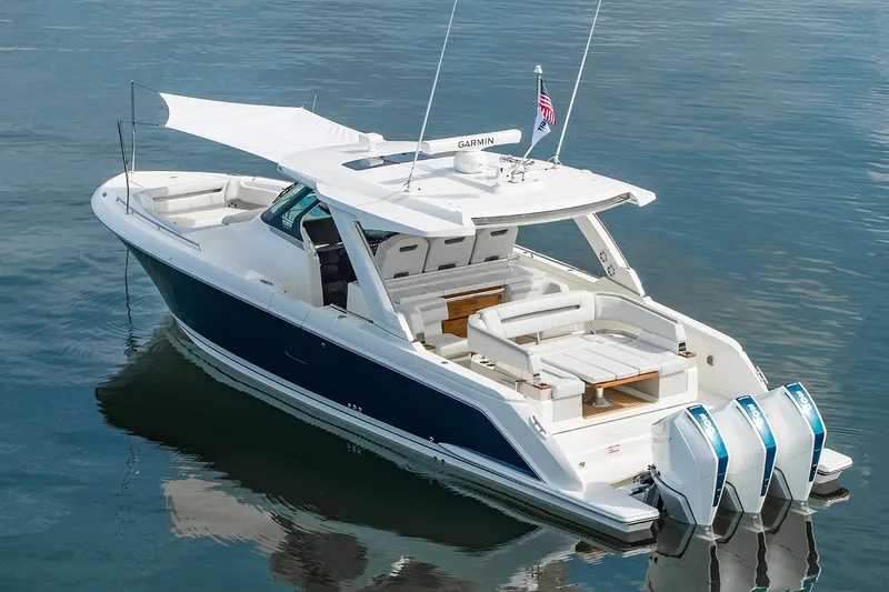  Yacht Photos Pics Manufacturer Provided Image: 2025 Tiara Yachts 38 LS luxury boat with triple engines on calm water.