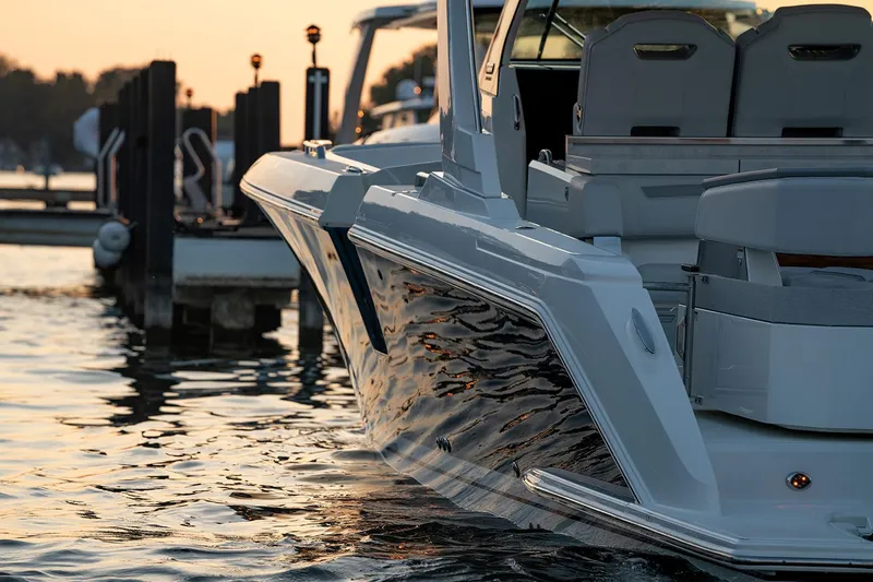  Yacht Photos Pics Manufacturer Provided Image: 2025 Tiara Yachts 38 LS docked at sunset, reflecting on calm water.