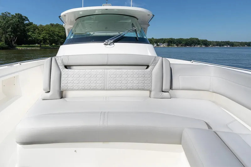 Diamond Pearl Yacht Photos Pics Manufacturer Provided Image: 2024 Tiara Yachts 38 LS boat with luxurious seating on a calm lake.