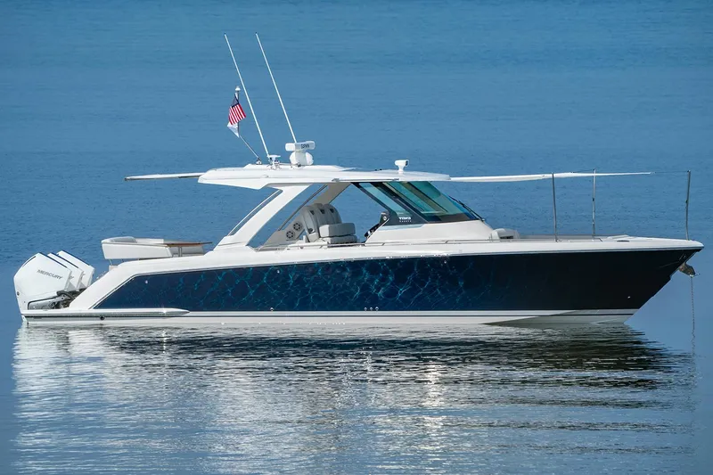  Yacht Photos Pics Manufacturer Provided Image: 2025 Tiara Yachts 38 LS luxury boat on calm water, side view.