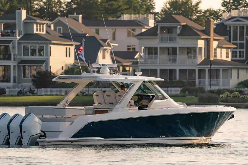  Yacht Photos Pics Manufacturer Provided Image: 2025 Tiara Yachts 38 LS cruising near waterfront homes.