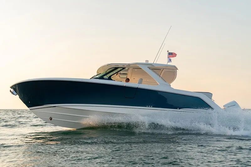  Yacht Photos Pics Manufacturer Provided Image: 2025 Tiara Yachts 38 LS cruising on water at sunset.