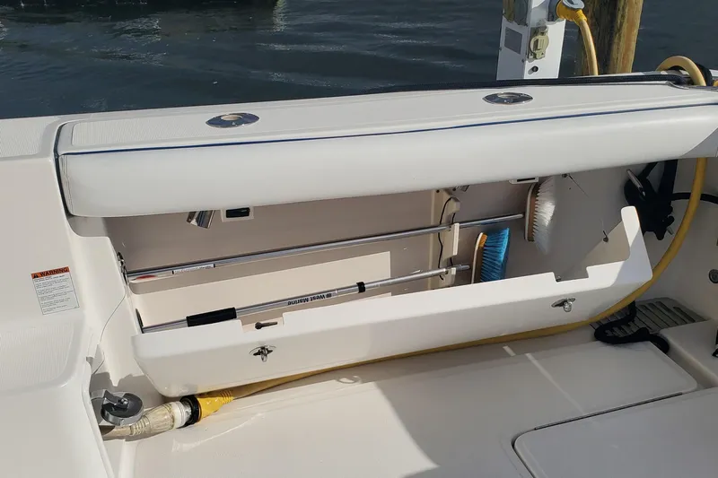 Cruse Yacht Photos Pics Storage compartment on a 2006 Tiara Yachts 4200 Open, featuring cleaning tools and equipment.