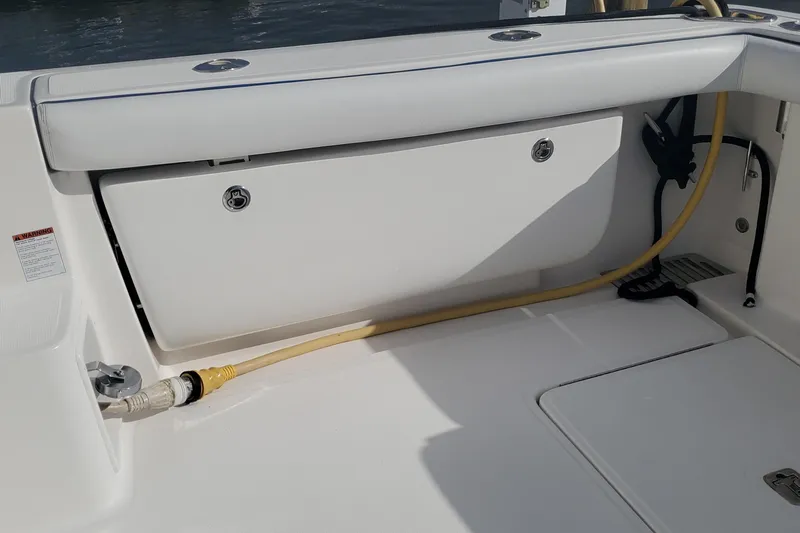 Cruse Yacht Photos Pics 2006 Tiara Yachts 4200 Open deck with storage compartment and yellow hose.