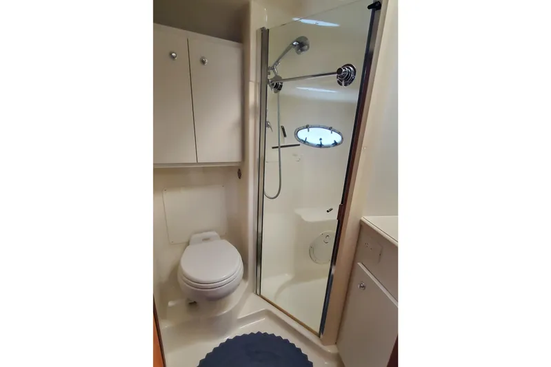 Cruse Yacht Photos Pics 2006 Tiara Yachts 4200 Open bathroom with shower, toilet, and storage cabinets.