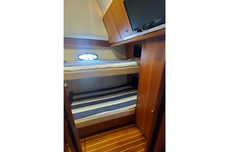 Cruse Yacht Photos Pics 2006 Tiara Yachts 4200 Open cabin with bunk beds and striped bedding.