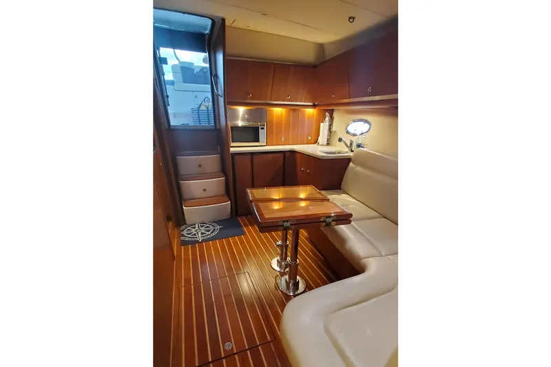 Cruse Yacht Photos Pics Luxurious 2006 Tiara Yachts 4200 Open interior with elegant wood finish and cozy seating.