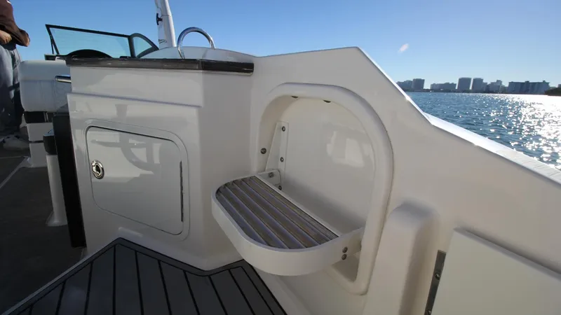 Finding Dori Yacht Photos Pics 2017 Sea Ray SDX 290 Outboard boat interior with seating and storage, overlooking water.