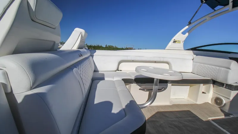 Finding Dori Yacht Photos Pics 2017 Sea Ray SDX 290 Outboard interior with white seating and table under clear blue sky.