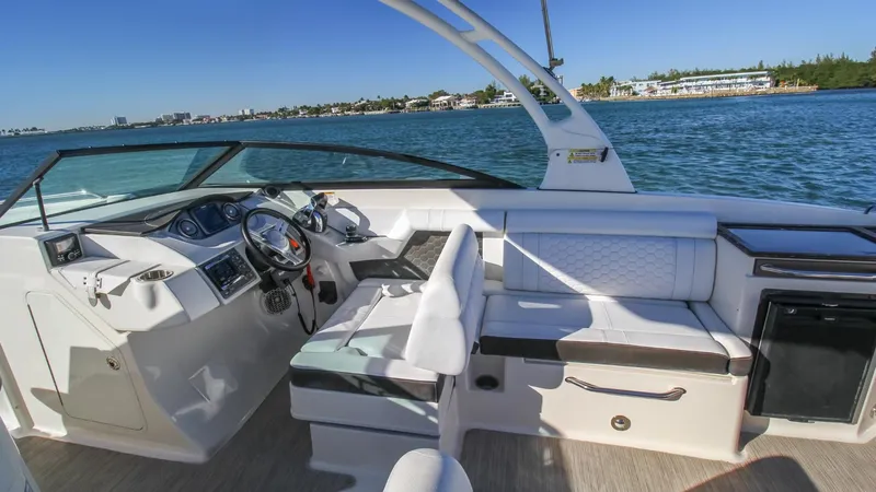 Finding Dori Yacht Photos Pics 2017 Sea Ray SDX 290 Outboard boat interior with seating and steering, on a sunny day.