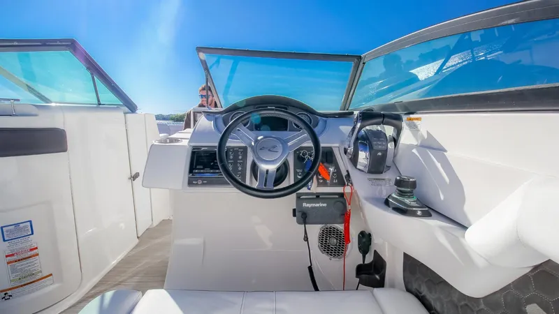 Finding Dori Yacht Photos Pics 2017 Sea Ray SDX 290 Outboard helm with steering wheel and controls under clear blue sky.