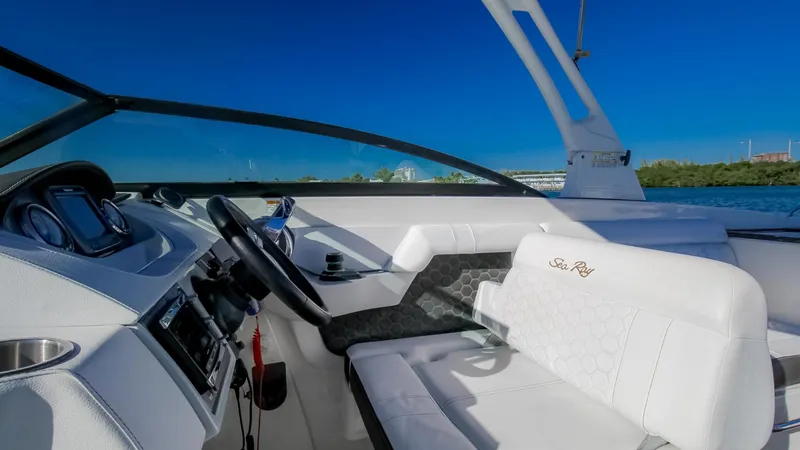 Finding Dori Yacht Photos Pics 2017 Sea Ray SDX 290 Outboard boat interior with white seating and steering wheel.