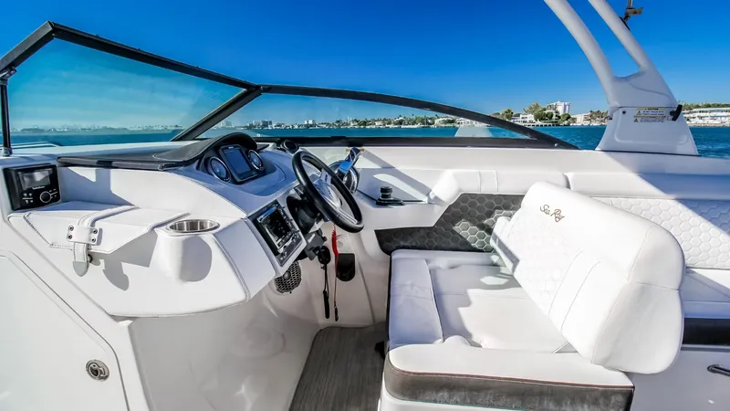 Finding Dori Yacht Photos Pics 2017 Sea Ray SDX 290 Outboard boat interior with steering wheel and seating, on a sunny day.