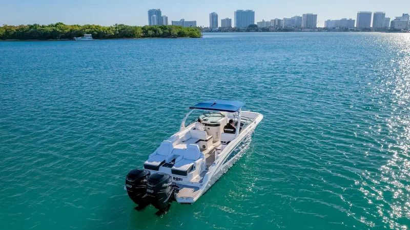 Finding Dori Yacht Photos Pics 2017 Sea Ray SDX 290 Outboard cruising on a sunny day with city skyline backdrop.