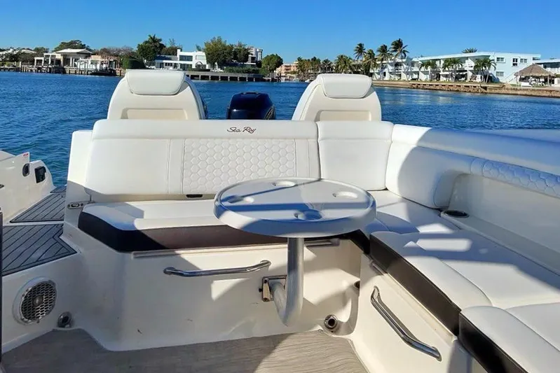 Finding Dori Yacht Photos Pics 2017 Sea Ray SDX 290 Outboard boat interior with seating and table, on a sunny day.