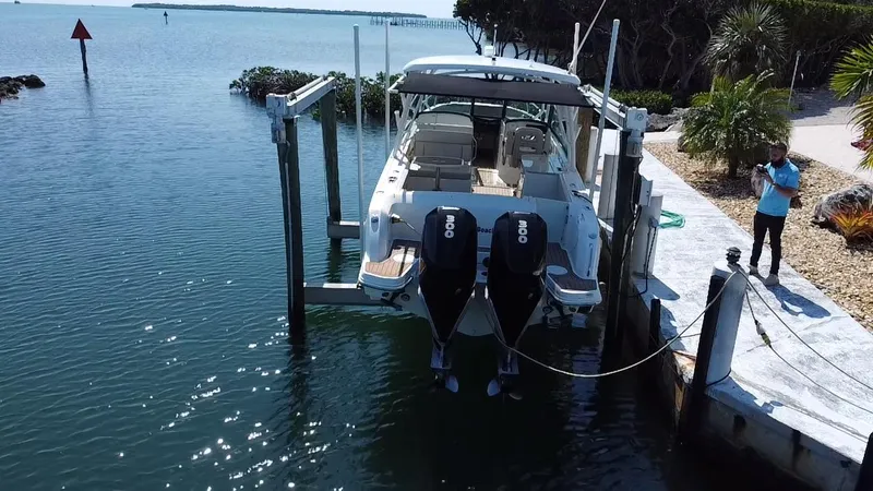  Yacht Photos Pics 2019 Boston Whaler 270 Vantage boat docked with dual engines in a scenic waterfront setting.
