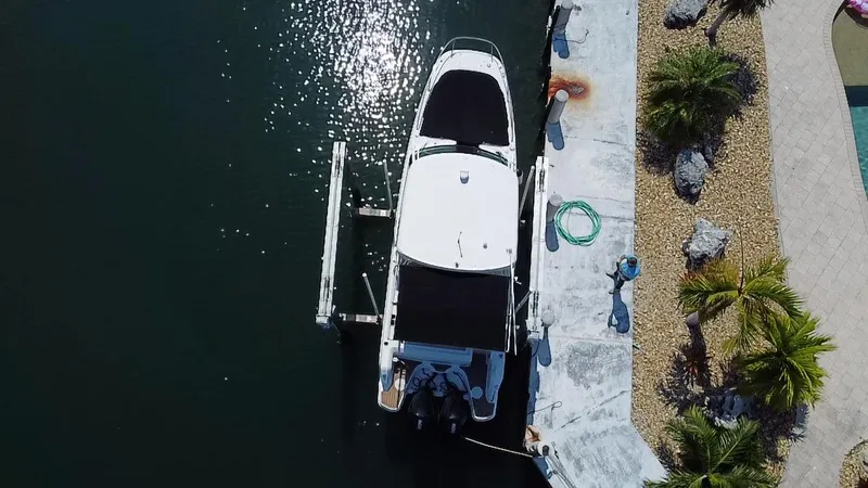  Yacht Photos Pics Aerial view of 2019 Boston Whaler 270 Vantage docked by a landscaped shoreline.