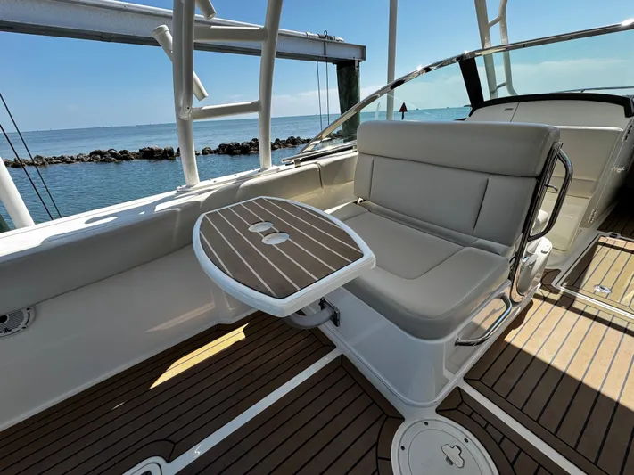  Yacht Photos Pics 2019 Boston Whaler 270 Vantage boat interior with seating and table, overlooking the ocean.