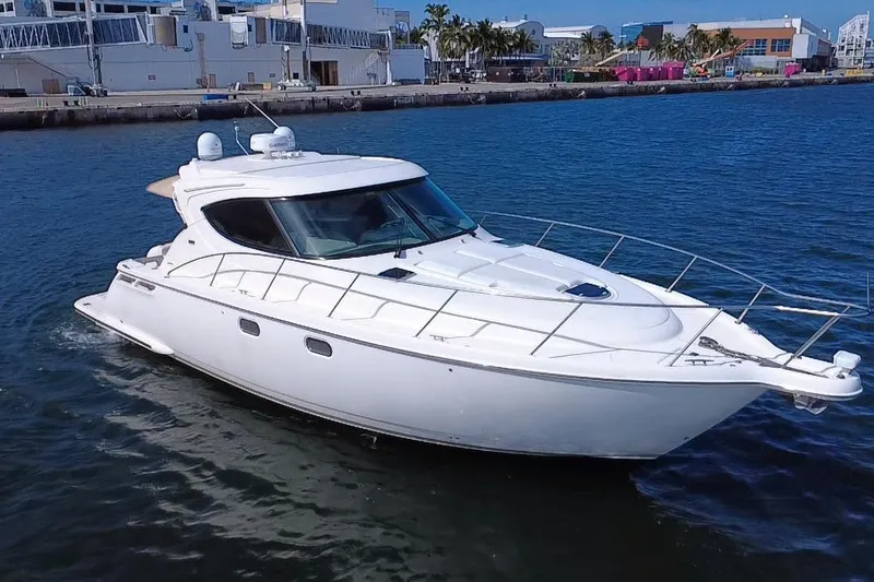  Yacht Photos Pics 2011 Tiara Yachts 4500 Sovran cruising in a marina, showcasing sleek design and luxury.