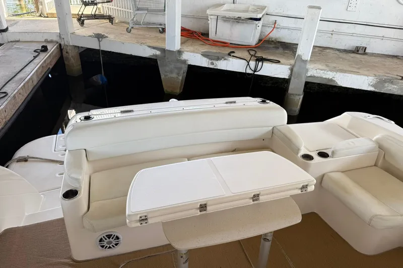  Yacht Photos Pics 2011 Tiara Yachts 4500 Sovran interior with white seating and table in docked setting.