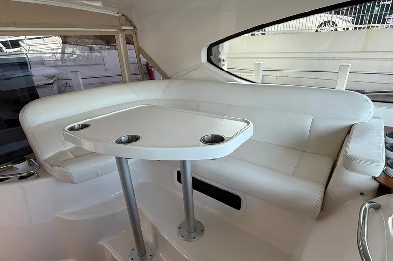 Yacht Photos Pics Interior seating area of 2011 Tiara Yachts 4500 Sovran with white upholstery and table.