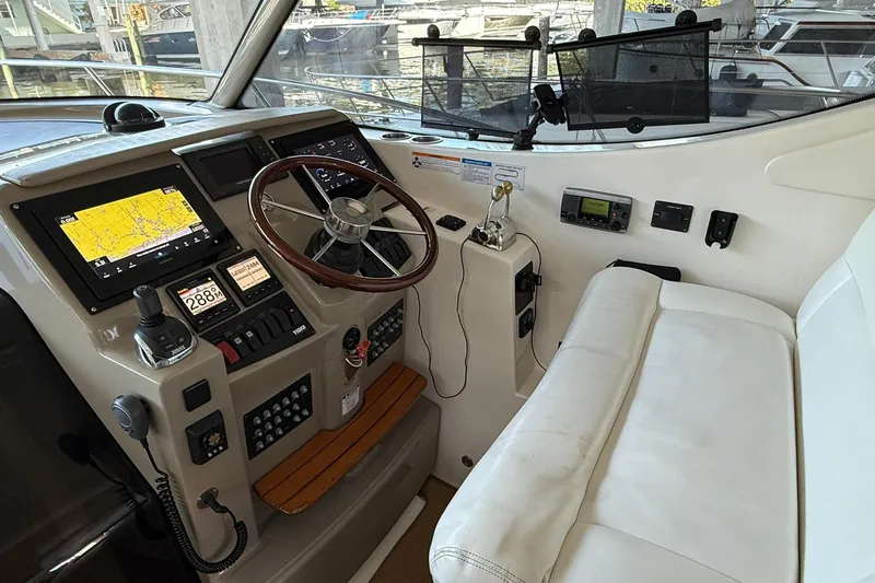  Yacht Photos Pics 2011 Tiara Yachts 4500 Sovran helm with navigation screens and steering wheel.