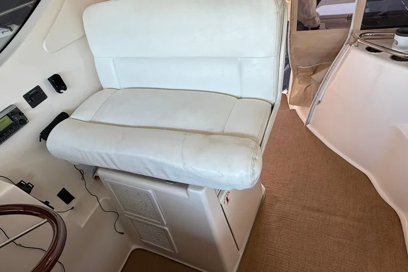  Yacht Photos Pics Captain's seat on 2011 Tiara Yachts 4500 Sovran, featuring white upholstery and control panel.