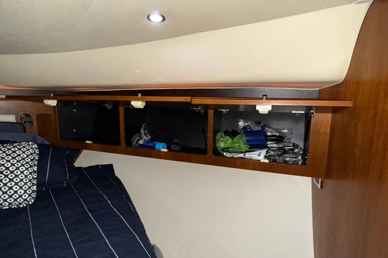  Yacht Photos Pics 2011 Tiara Yachts 4500 Sovran cabin storage with open compartments and bedding.