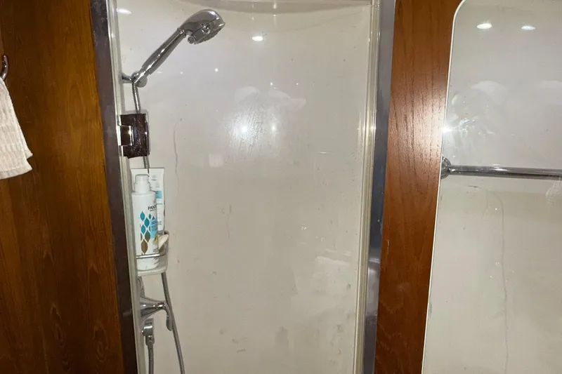  Yacht Photos Pics Shower area in 2011 Tiara Yachts 4500 Sovran, featuring wooden accents and modern fixtures.