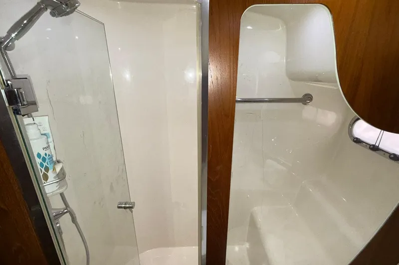  Yacht Photos Pics Luxurious shower area in 2011 Tiara Yachts 4500 Sovran, featuring glass door and wooden accents.