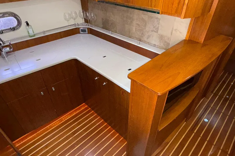  Yacht Photos Pics Luxurious 2011 Tiara Yachts 4500 Sovran kitchen with wood cabinetry and modern amenities.