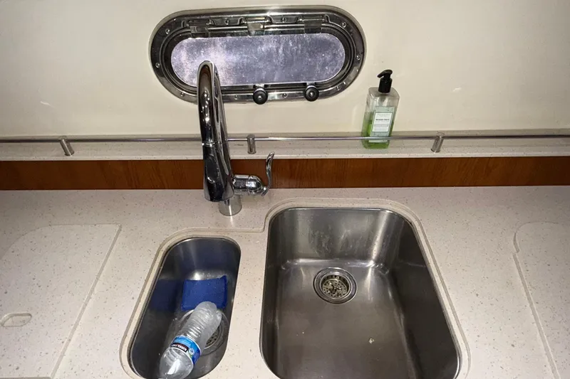  Yacht Photos Pics Kitchen sink area on a 2011 Tiara Yachts 4500 Sovran with porthole and soap dispenser.