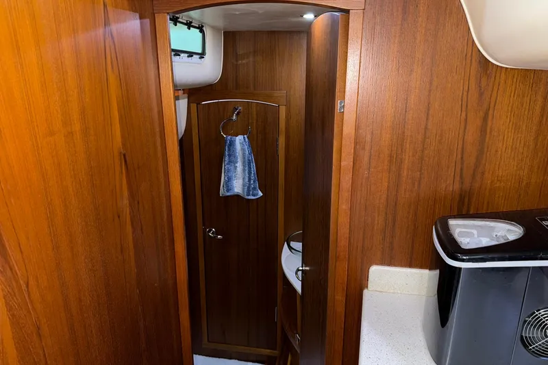  Yacht Photos Pics Interior of 2011 Tiara Yachts 4500 Sovran with wooden cabinetry and compact amenities.