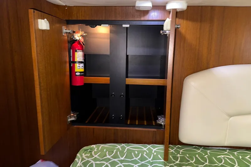 Yacht Photos Pics Open wooden cabinet with fire extinguisher inside Tiara Yachts 4500 Sovran, 2011 model.