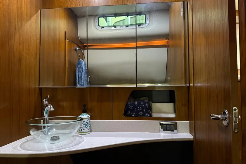  Yacht Photos Pics Luxurious bathroom in 2011 Tiara Yachts 4500 Sovran with glass sink and mirrored cabinet.