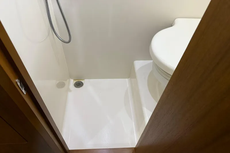  Yacht Photos Pics Compact bathroom in 2011 Tiara Yachts 4500 Sovran, featuring shower and toilet.