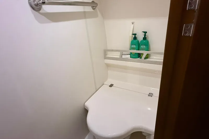  Yacht Photos Pics Bathroom interior of 2011 Tiara Yachts 4500 Sovran with toiletries on shelf.