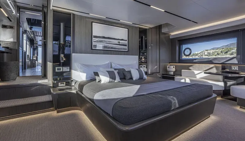  Yacht Photos Pics Luxurious bedroom interior of 2025 Pearl 82 yacht with modern design and scenic window view.