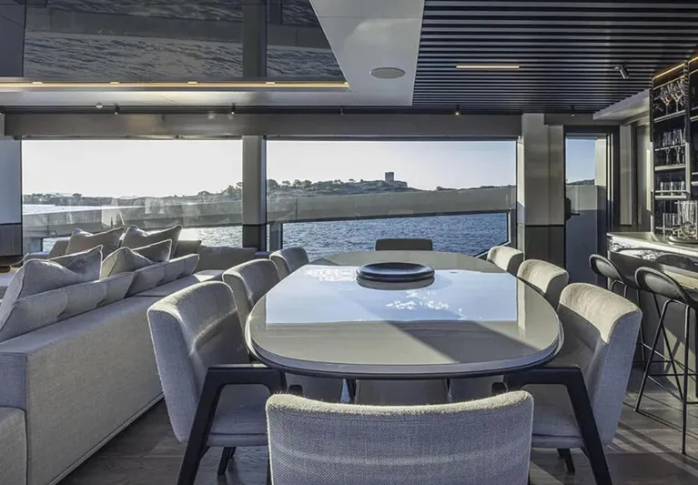  Yacht Photos Pics Luxurious interior of 2025 Pearl 82 yacht with elegant dining area and ocean view.
