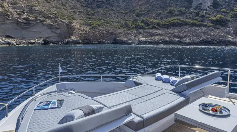  Yacht Photos Pics Luxurious Pearl 82 yacht deck with sun loungers, scenic coastal view, 2025 model.