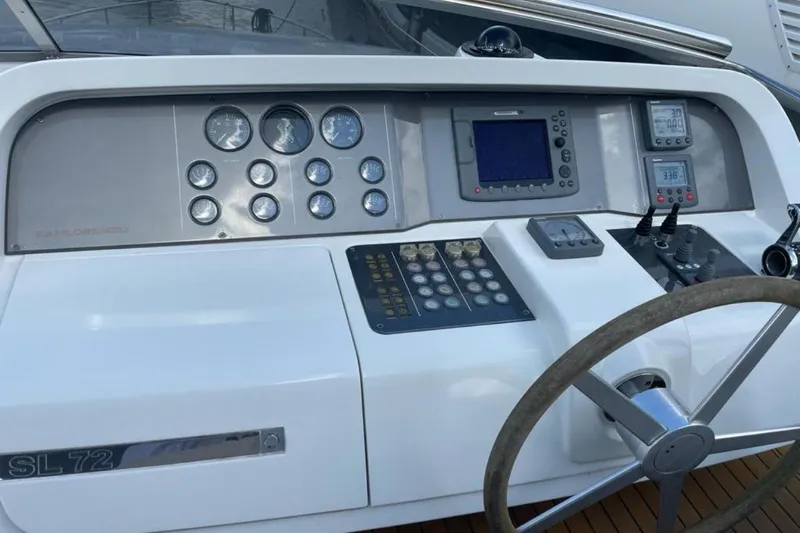  Yacht Photos Pics Control panel of 2010 Sanlorenzo SL72 yacht with steering wheel and navigation instruments.