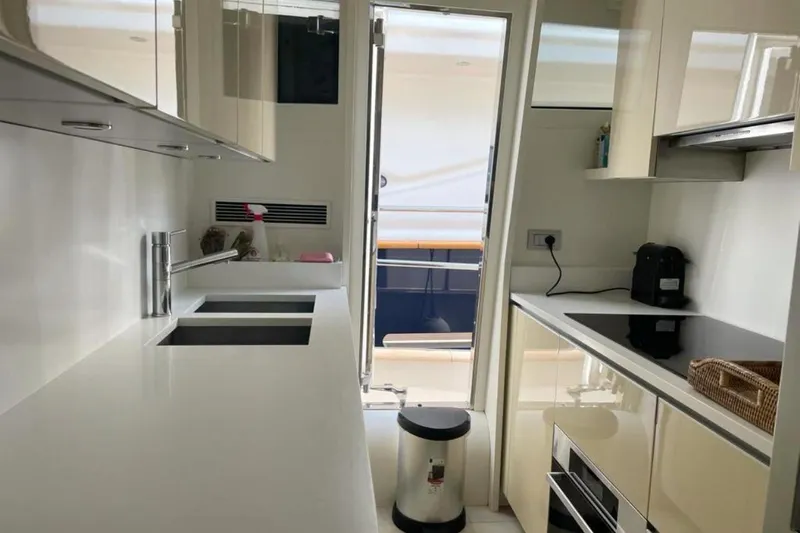  Yacht Photos Pics Modern kitchen interior on a 2010 Sanlorenzo SL72 yacht, featuring sleek countertops and appliances.